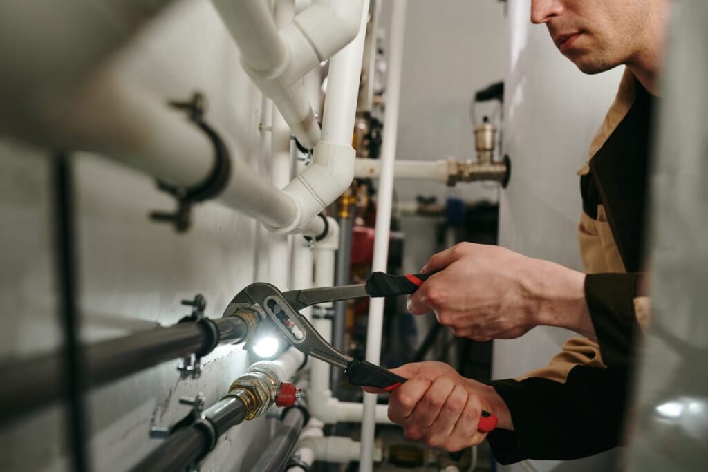 Plumbers maintaining commercial plumbing pipes in Wheat Ridge