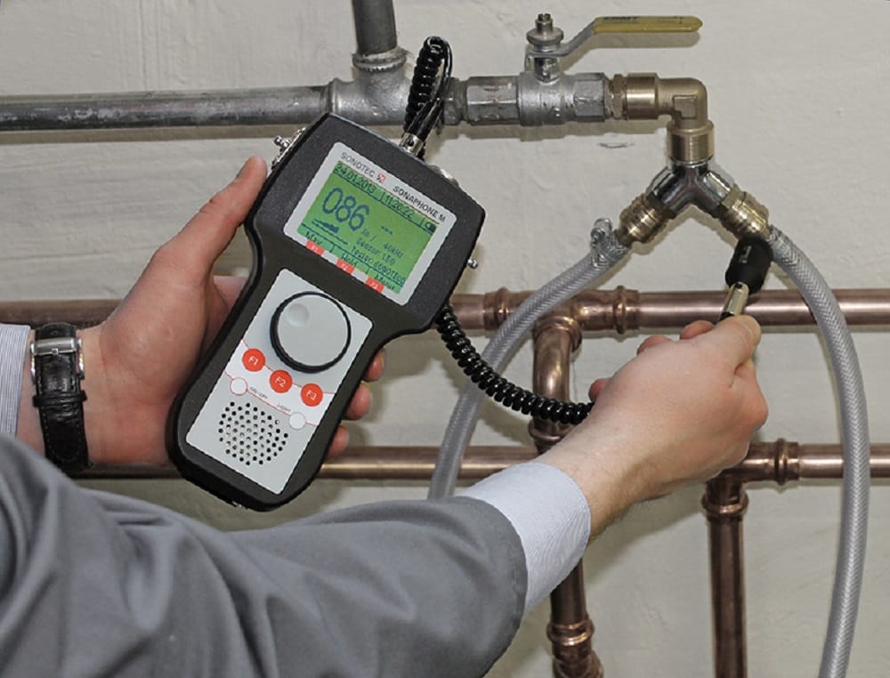 Plumber testing pipes with electronic leak detection equipment in Wheat Ridge