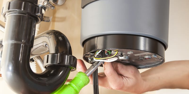 Technician repairing the heating element of a water heater in Wheat Ridge