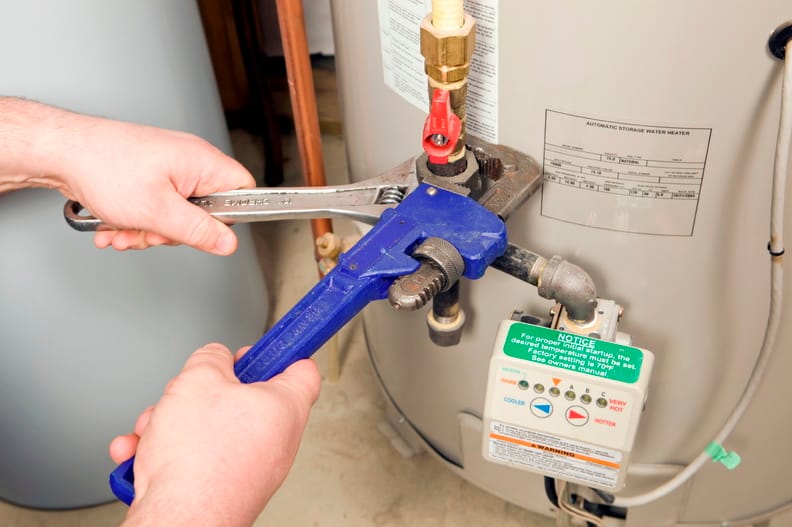 Plumber repairing a water heater valve in Wheat Ridge